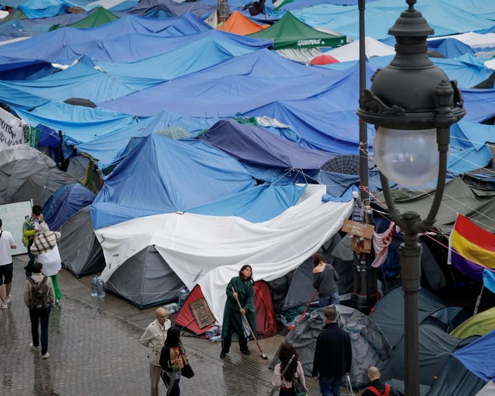 "Spain's Early Election: Housing Activists at Madrid Encampment Hold Hopeful Yet Cautious Outlook"